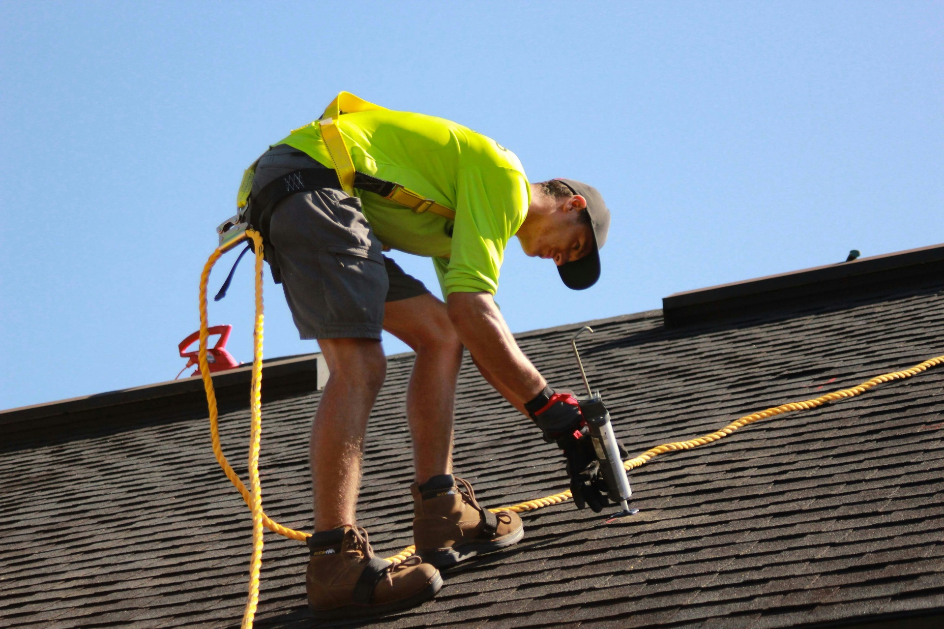 Roofer repairing asphalt shingles on residential home — roofing SEO content marketing strategy